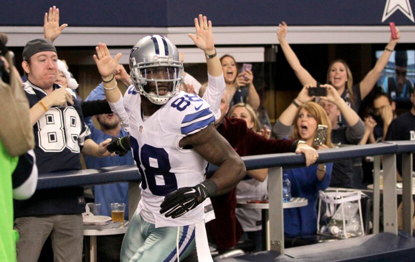 Dallas Cowboys wide receiver Dez Bryant (88) celebrates with a fan after scoring a touchdown...