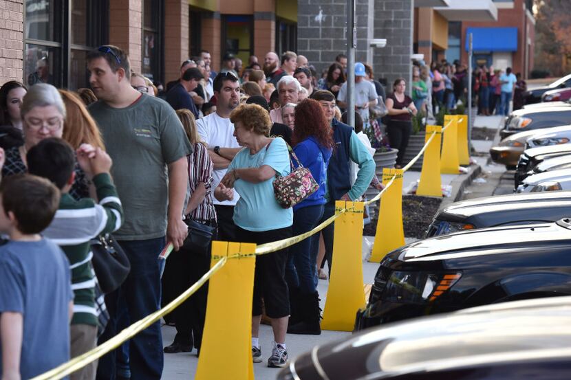 Early Black Friday shoppers stand in line as they wait for the door opens at 5 p.m. at Toys...
