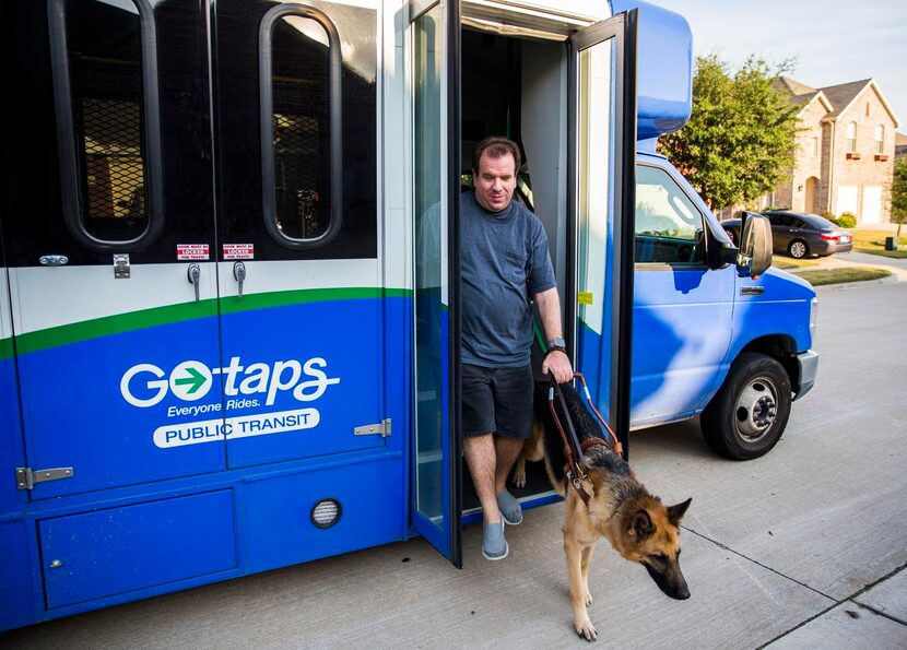 
Justin Mann and his guide dog, Garvey, arrive home after a TAPS Public Transit bus ride  in...