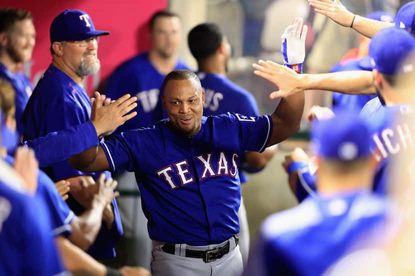 ANAHEIM, CA - AUGUST 23:  Adrian Beltre #29 of the Texas Rangers is congratulated in the...