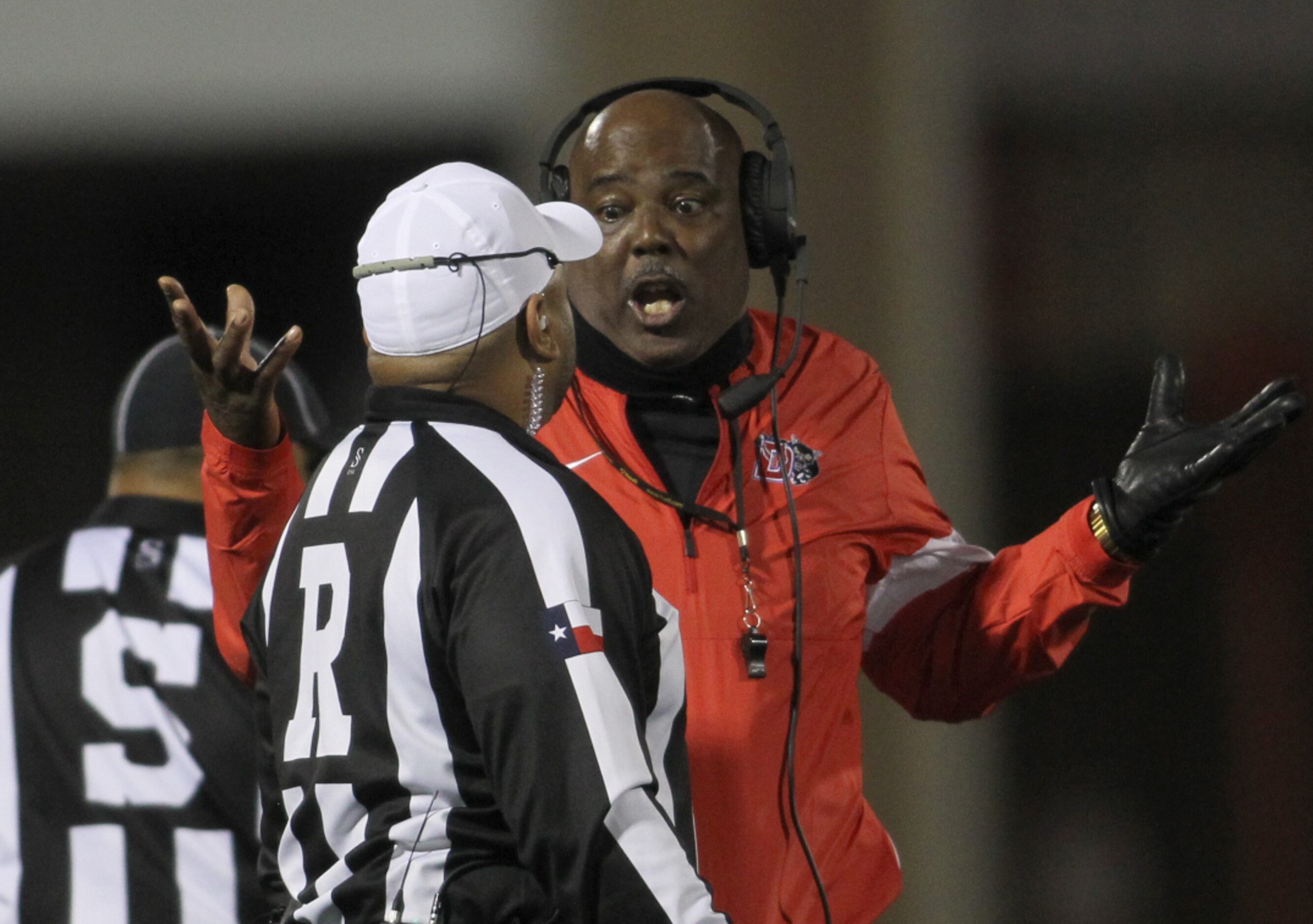 Duncanville Head coach Reginald Samples questions a call with a game official during the...