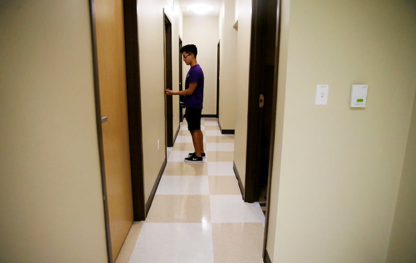 Erik Jimenez walks back to his dorm alone after his parents helped him move in.