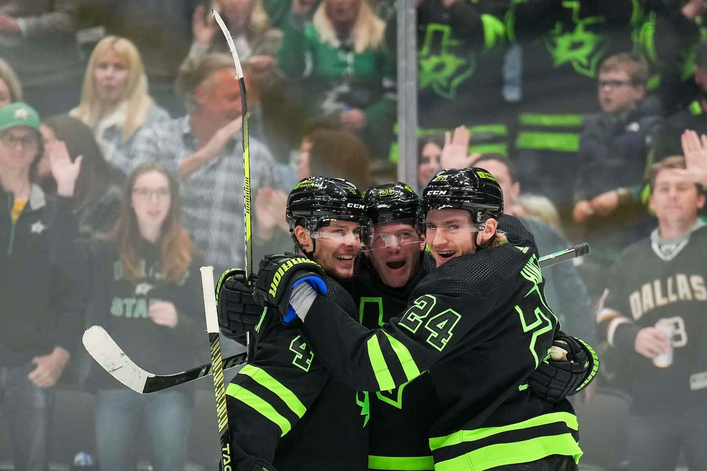 Dallas Stars defenseman Ryan Suter (20) celebrates with defenseman Miro Heiskanen (4) and...