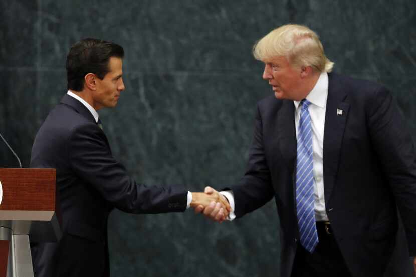 Mexico President Enrique Peña Nieto and Republican presidential nominee Donald Trump shook...