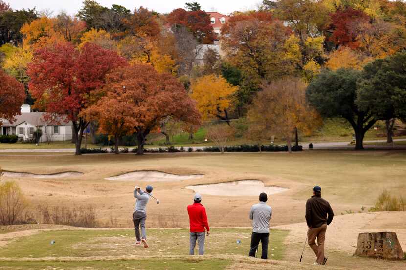 Fall color envelopes Stevens Park Golf Course in Dallas as Barry Streeter of Dallas tees off...