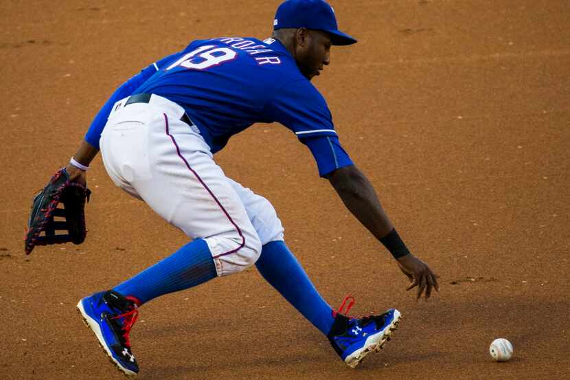 Texas Rangers first baseman Jurickson Profar (19) reaches to recover a ball during the...