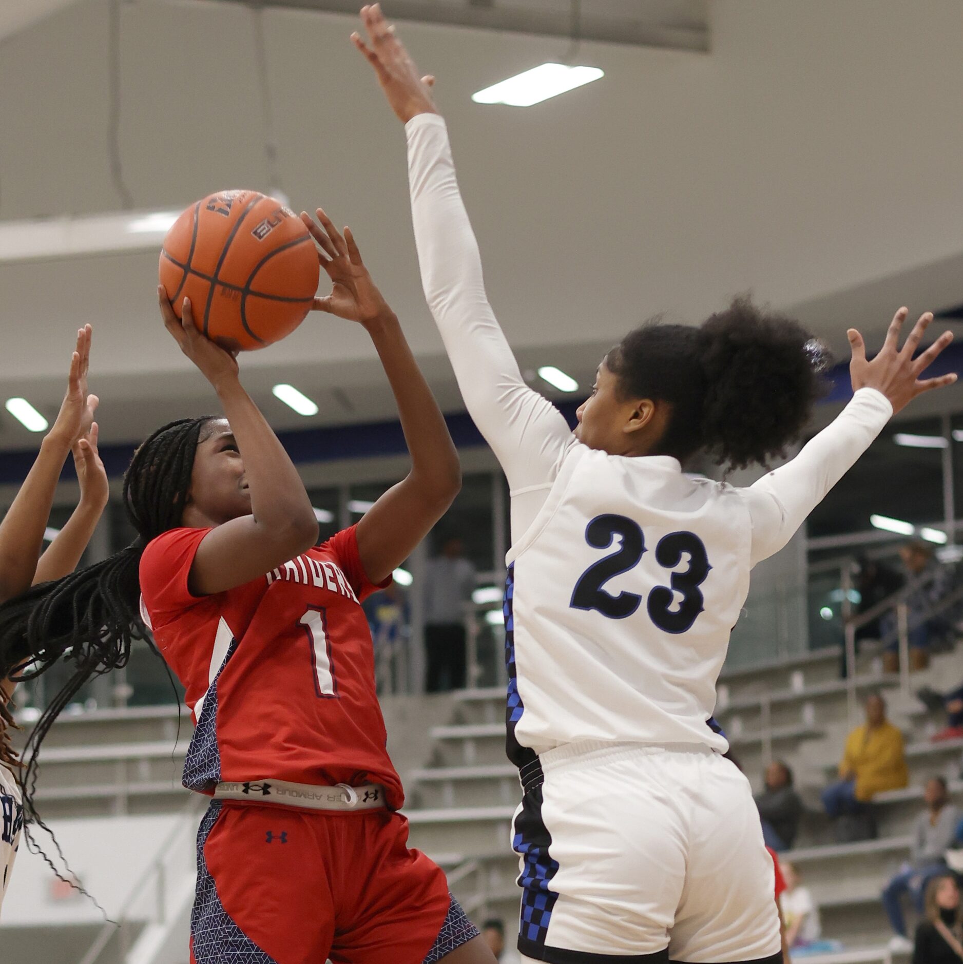 Denton Ryan guard Dashia Johnson (1), left, shoots against the defense of Hebron guard Paris...