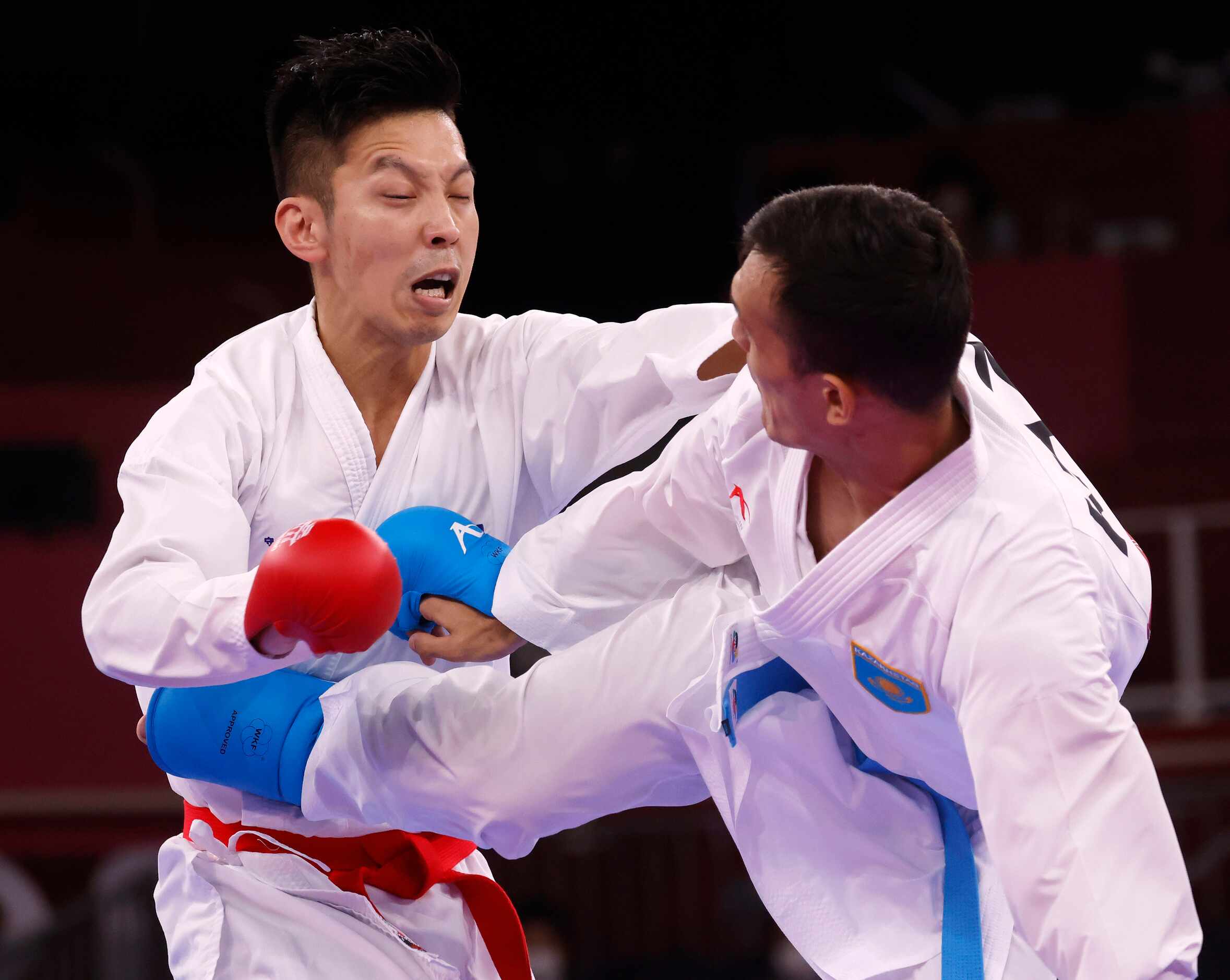 Kazakhstan’s Nurkanat Azhikanov kicks Australia’s Tsuneari Yahiro in the torso during the...