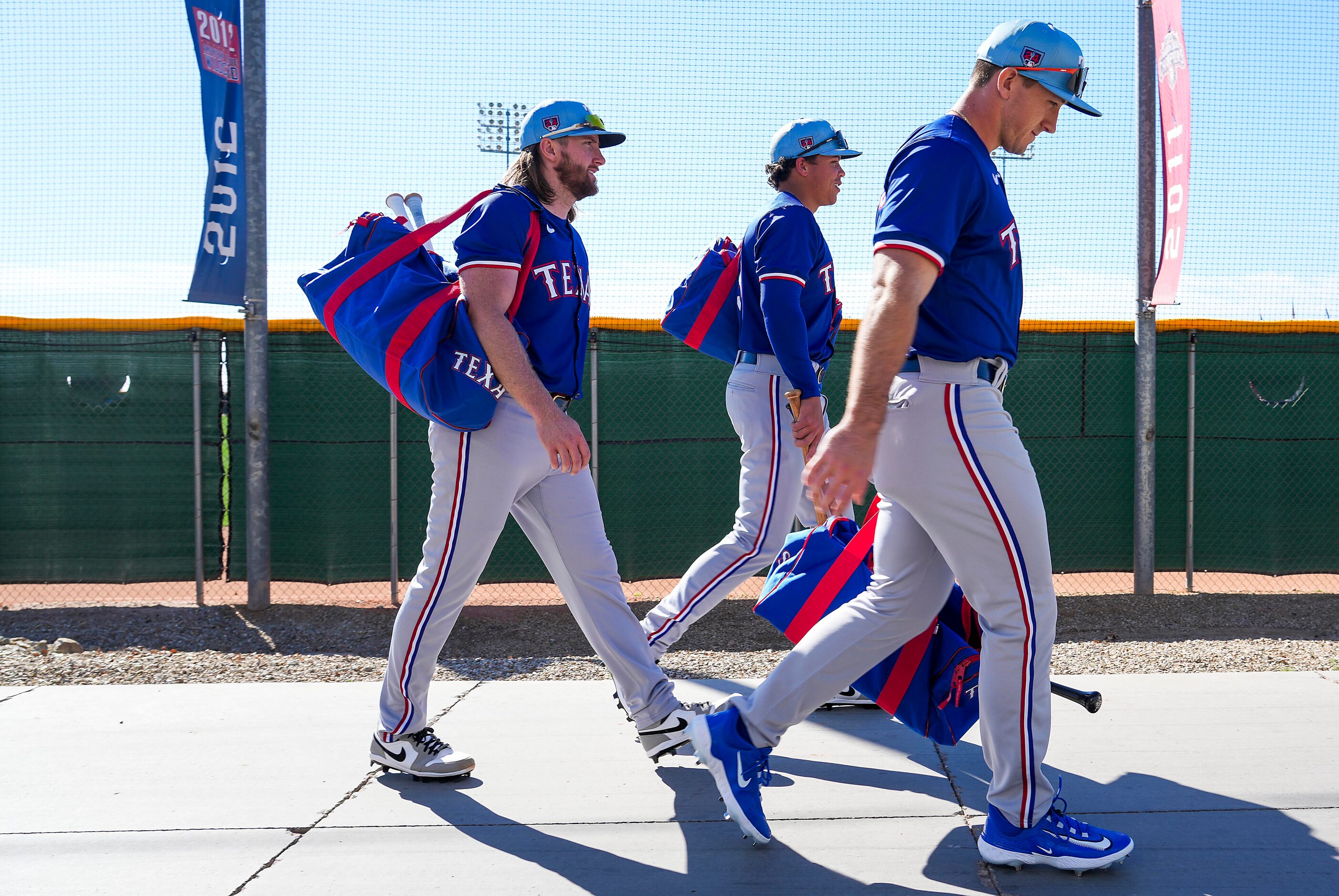 Texas Rangers outfielder Wyatt Langford (right), outfielder Dustin Harris (center), and...