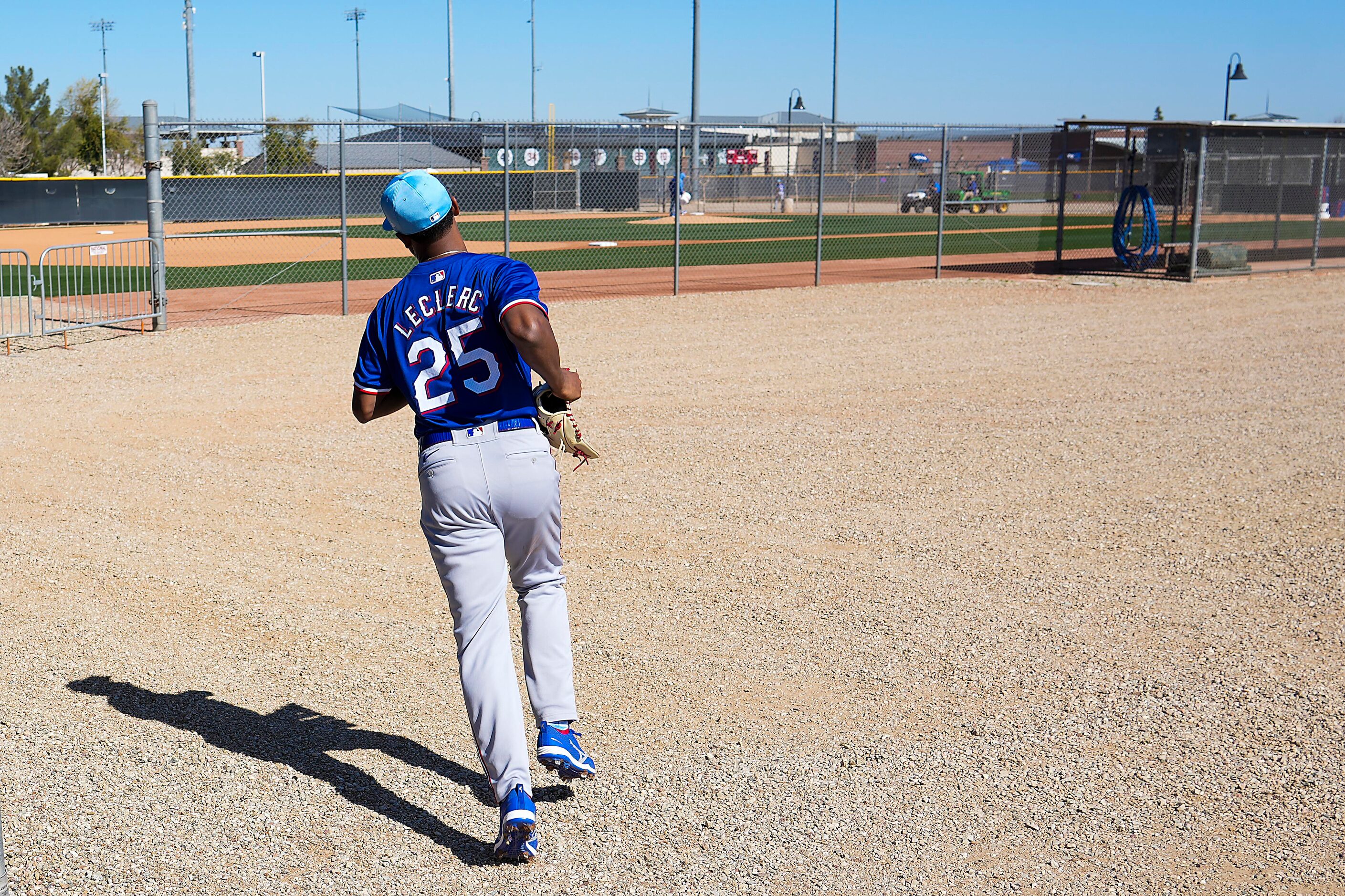 Texas Rangers pitcher José Leclerc runs between fields during the first Spring Training...