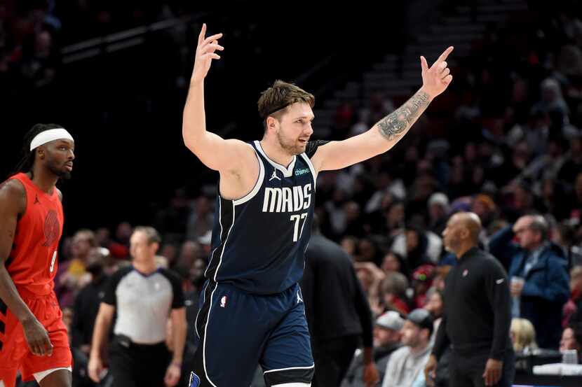 Dallas Mavericks guard Luka Doncic (77) reacts after a teammate hits a shot late in the game...