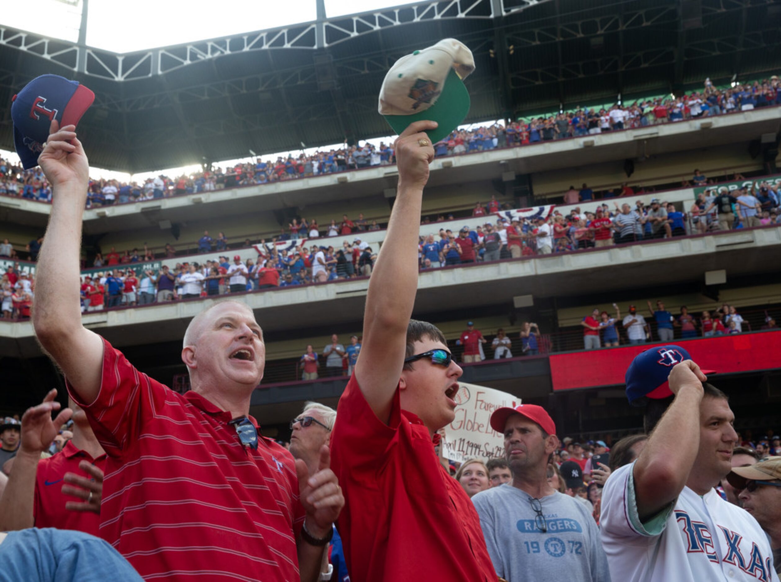 Frank Targac (left) sings "Take Me Out to the Ballgame" with his son, Allen Targac (center)...