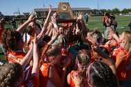  Celina players hoist the state Class 4A championship trophy following their 1-0 victory...