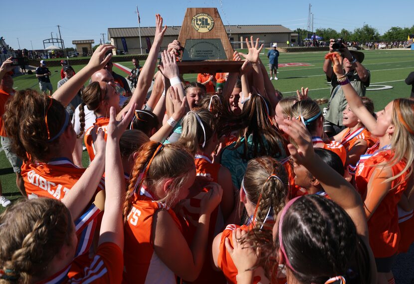  Celina players hoist the state Class 4A championship trophy following their 1-0 victory...