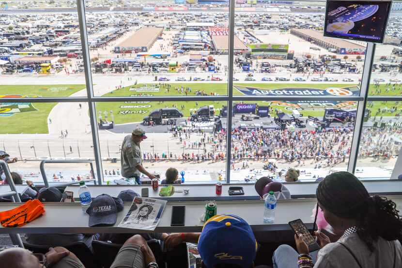Uvalde families and volunteers look out over the Fall NASCAR Playoffs with a box view hosted...