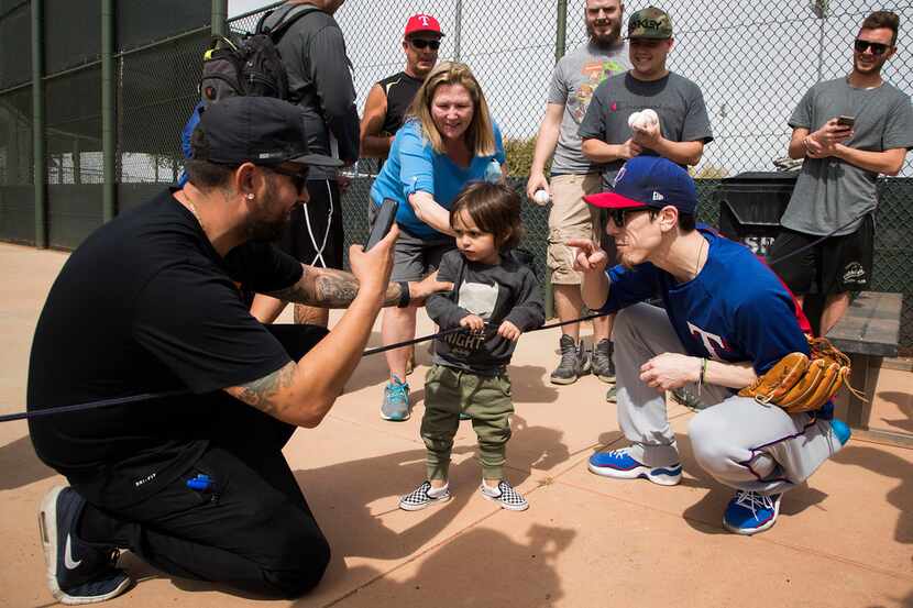 Texas Rangers pitcher Tim Lincecum poses for photos with fans after a spring training...