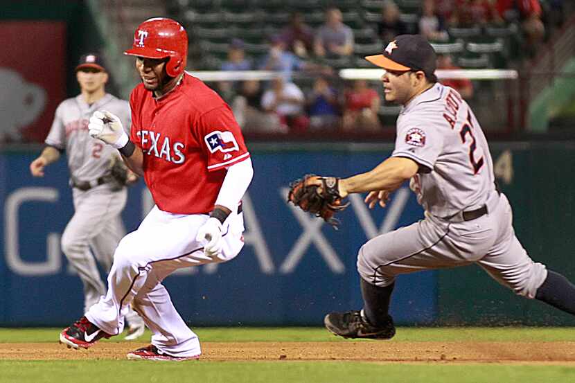 Texas Rangers shortstop Elvis Andrus (1) is caught i na pickle and tagged out by Houston...