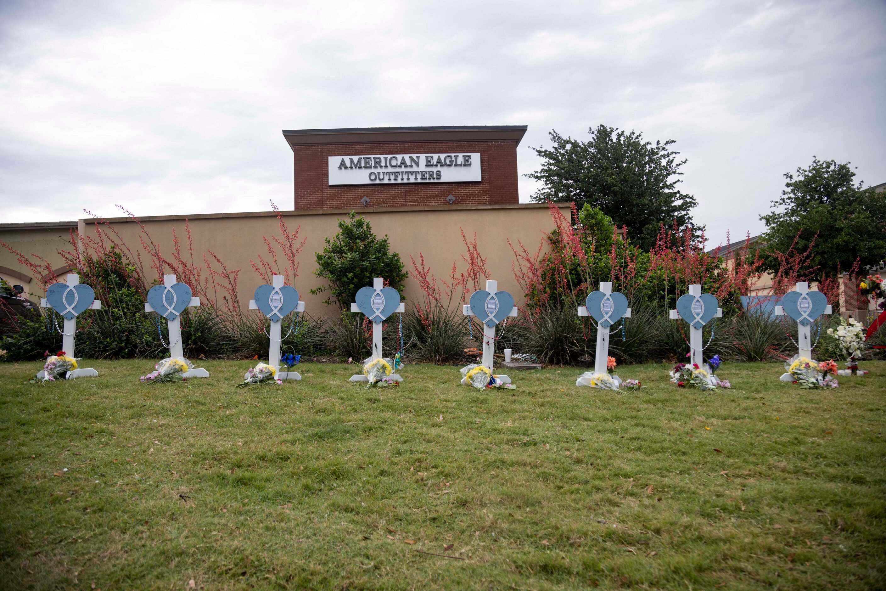 Eight crosses at memorial outside the mall after a mass shooting at Allen Premium Outlets in...