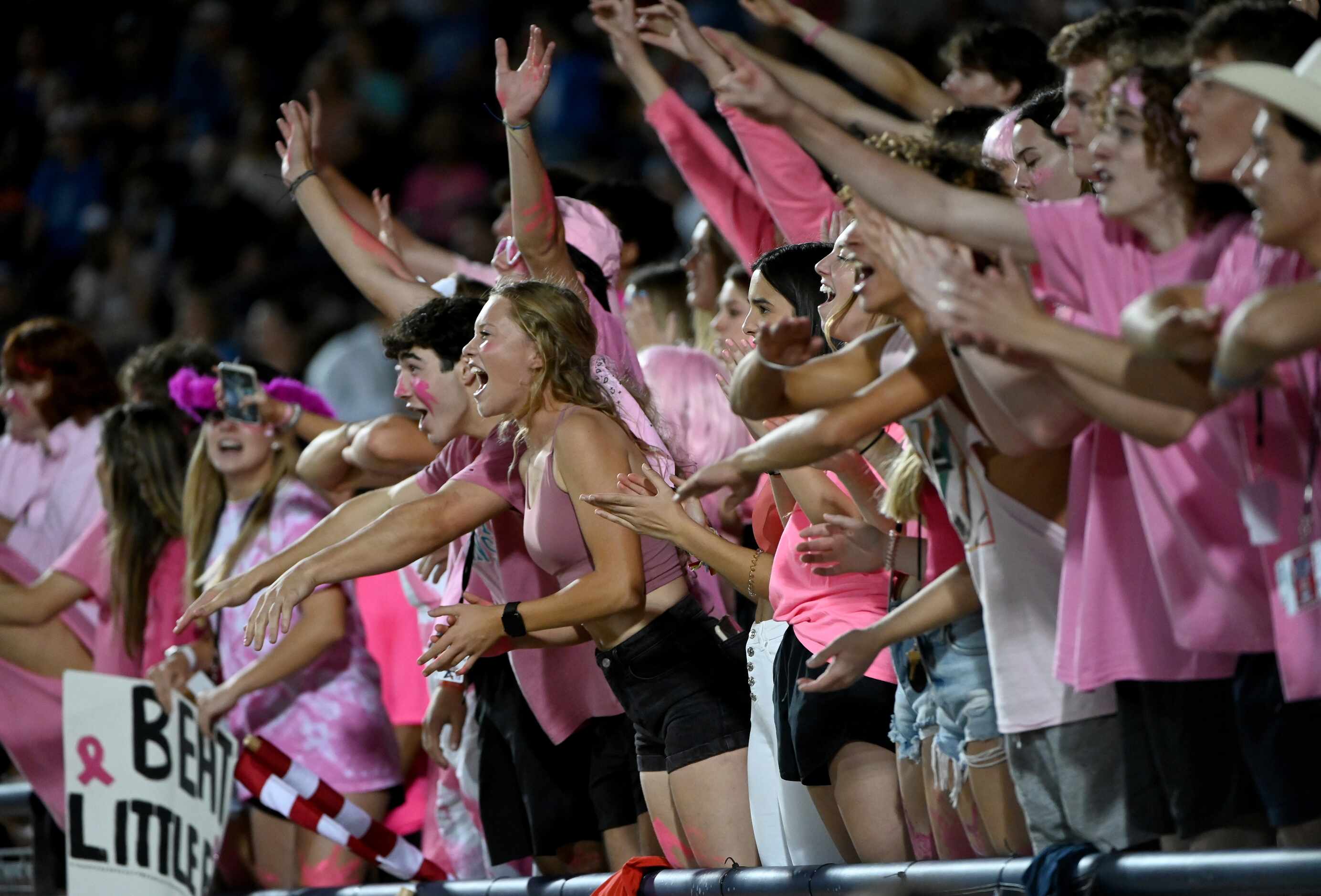 Allen students cheer in the first half of a high school football game between Little Elm and...