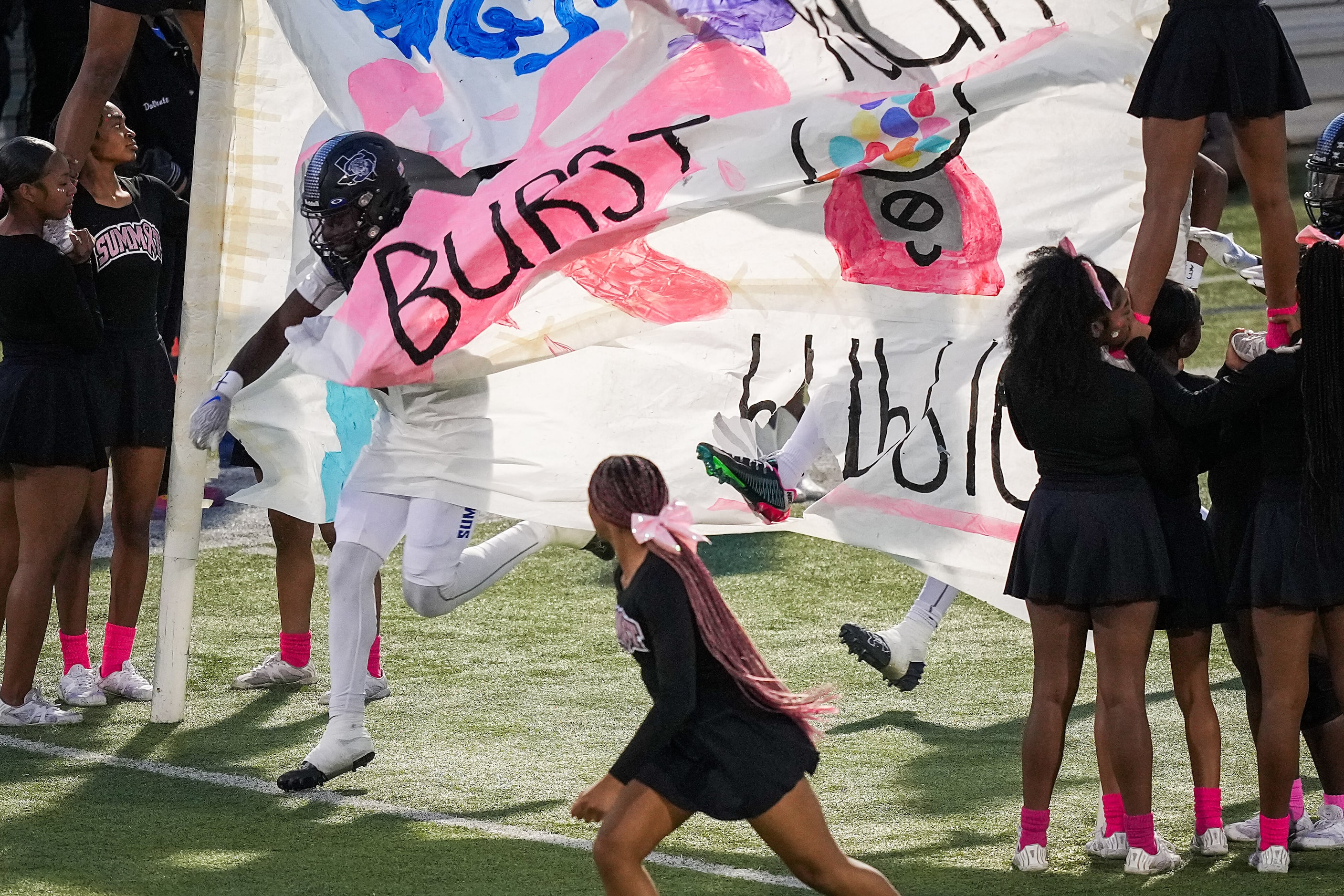 Mansfield Summit wide receiver Domonique Young is the first through the banner before a...