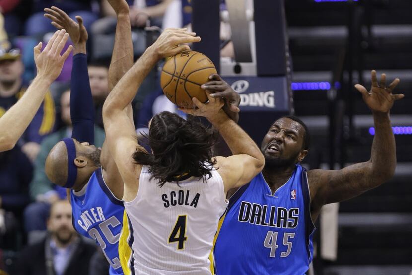 Indiana Pacers forward Luis Scola (4) is fouled as he shoots over Dallas Mavericks guard...