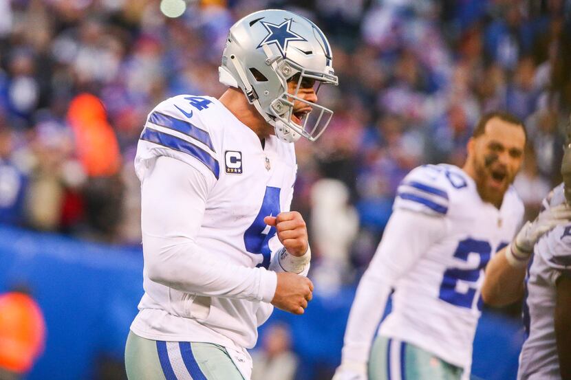 Cowboys quarterback Dak Prescott (4) celebrates after scoring a two-point conversion to take...