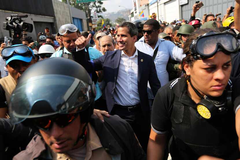 Venezuela's self-proclaimed interim president Juan Guaido greets supporters during an...