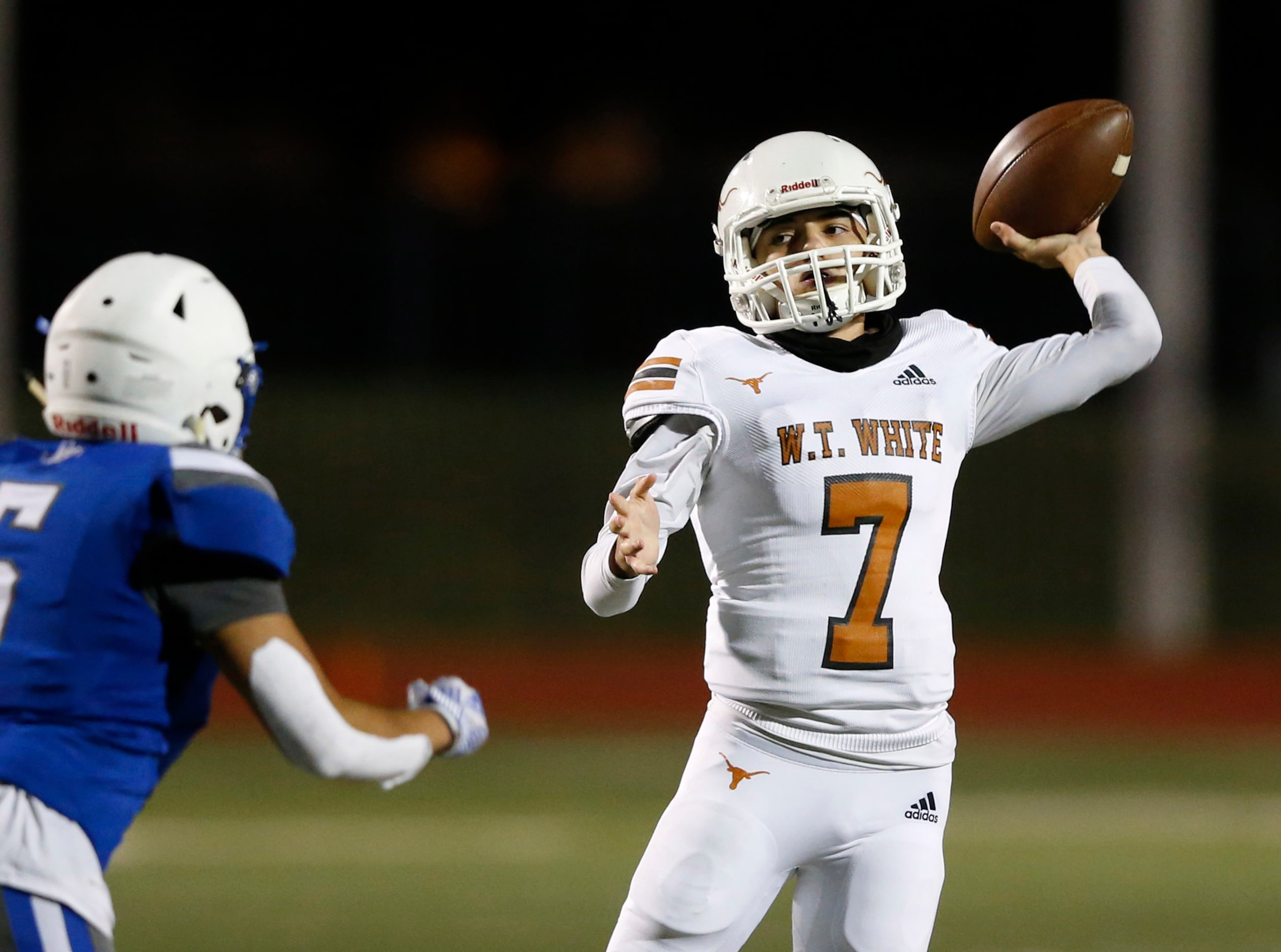 W.T. White's Jason Salinas (7) attempts a pass in front of Carrollton R.L. Turner's Seth...