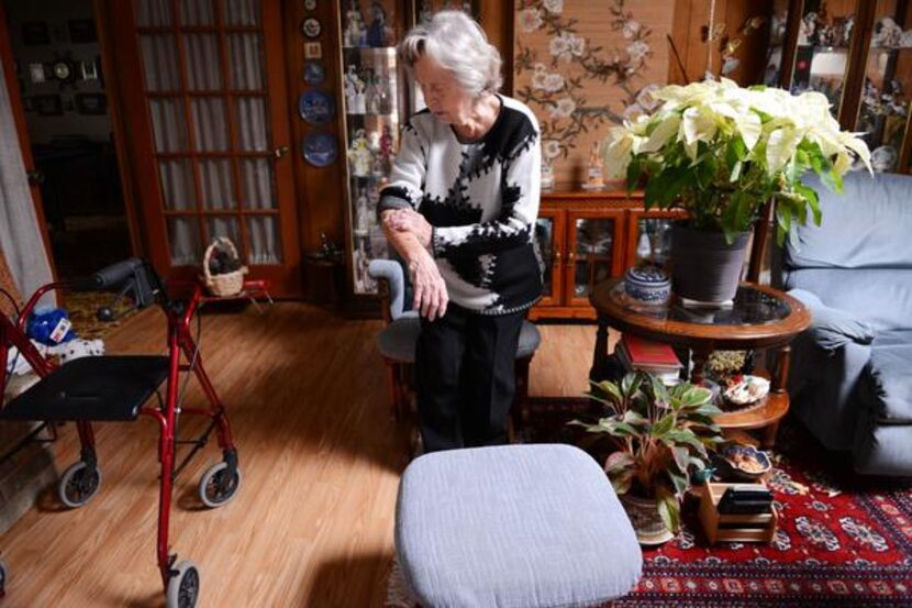 
Greta Watts, 94, fixes a bandage on her arm. “I don’t know what I’d do without her,” said...