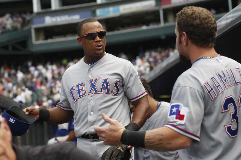 Texas Rangers third baseman Adrian Beltre, left, confers with left fielder Josh Hamilton as...