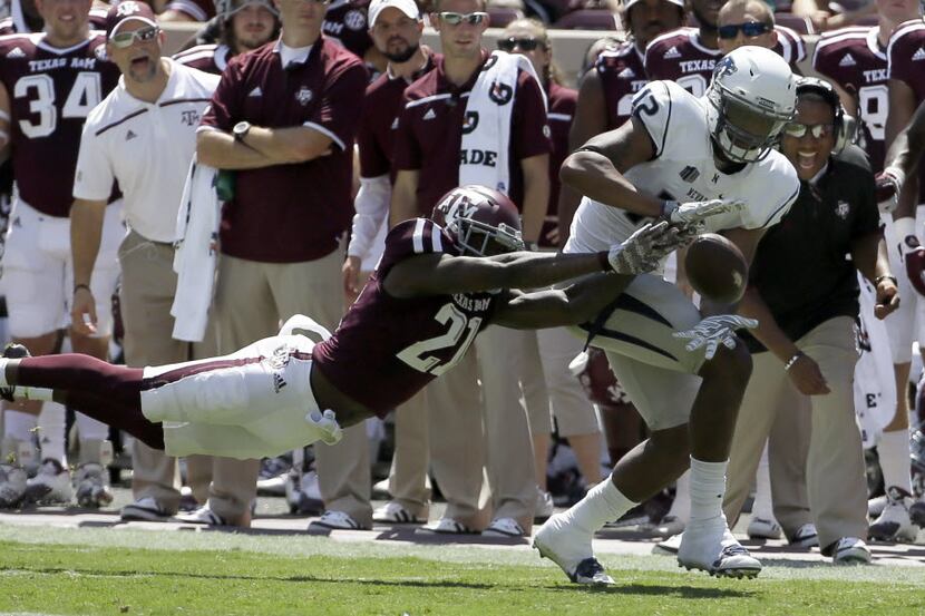 Texas A&M Brandon Williams (21) breaks up a pass intended for Nevada wide receiver Hasaan...
