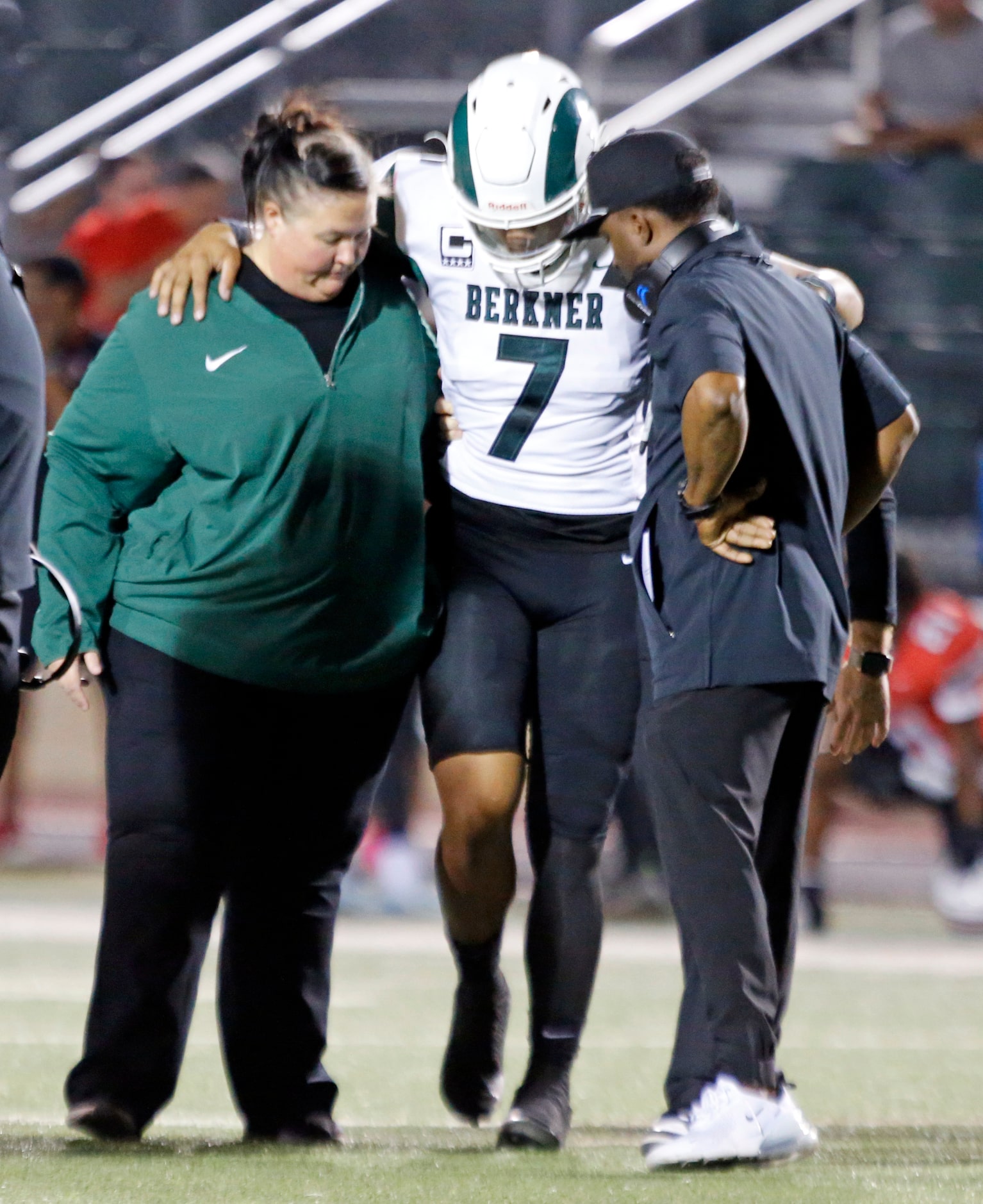 Richardson Berkner High QB Cornell McGee IV (7) is escorted off the field, after suffering...