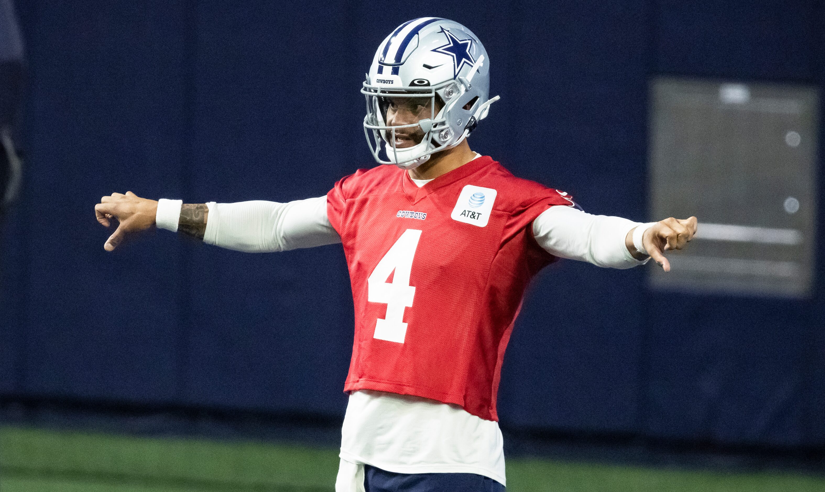 Dallas Cowboys quarterback Dak Prescott stretches during practice at The Star in Frisco,...