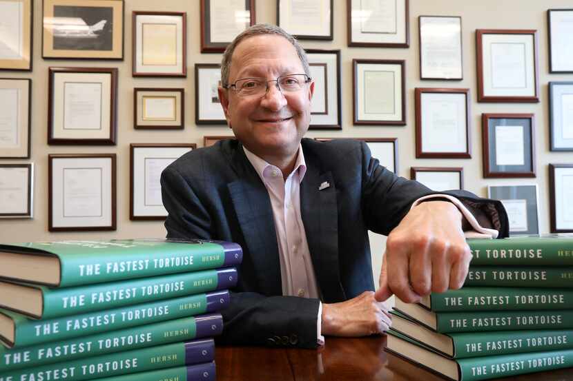 Ken Hersh poses with his book, The Fastest Tortoise, at the Hersh Family Investments office...