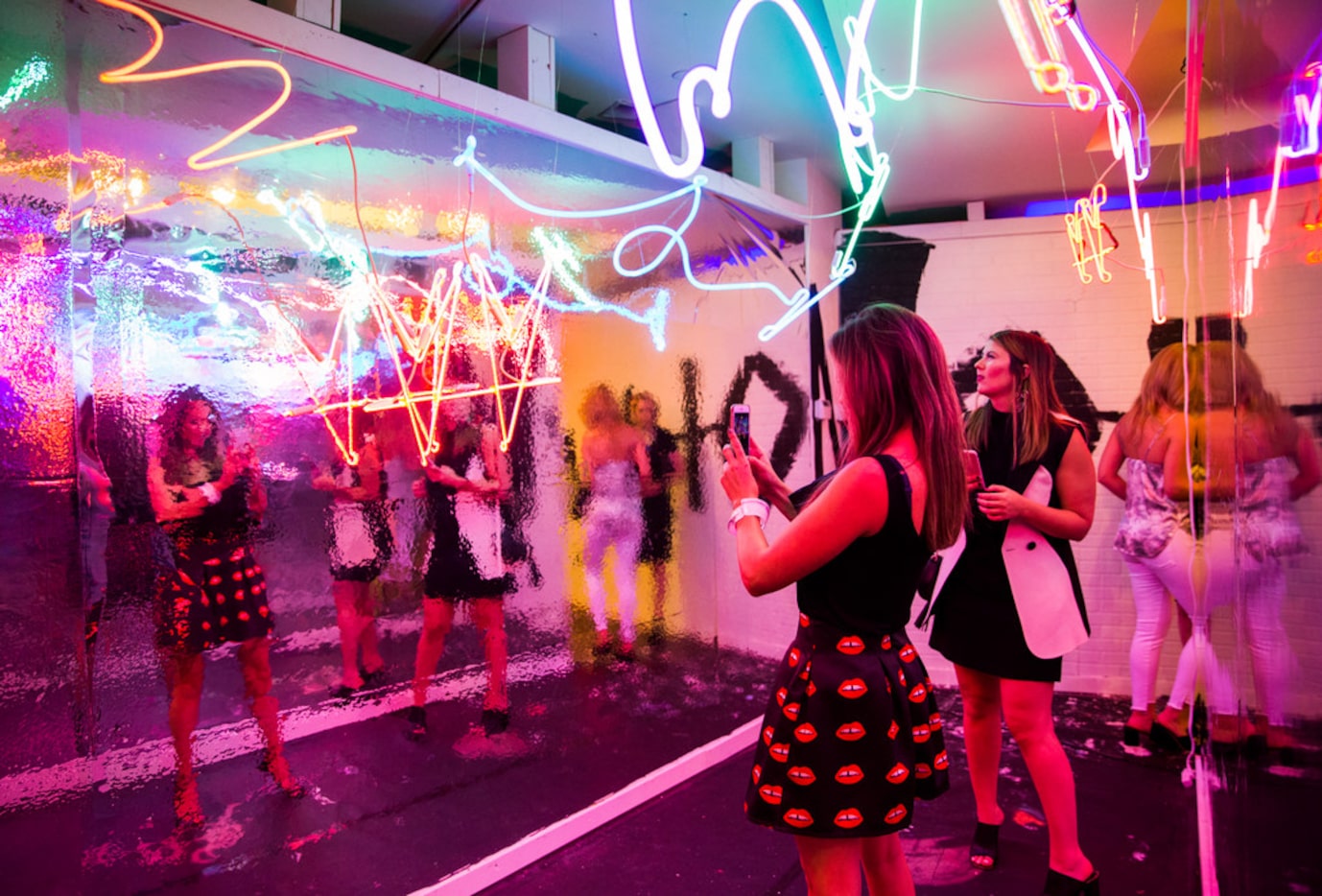 Women take photos inside artwork by Not.Travis inside a new pop-up art installation called...