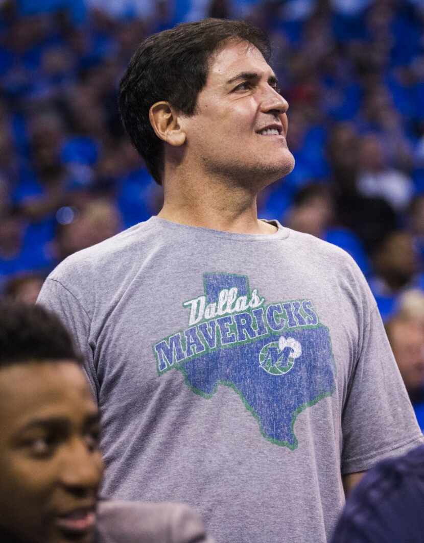 Dallas Mavericks owner Mark Cuban watches from behind the bench during the first quarter of...