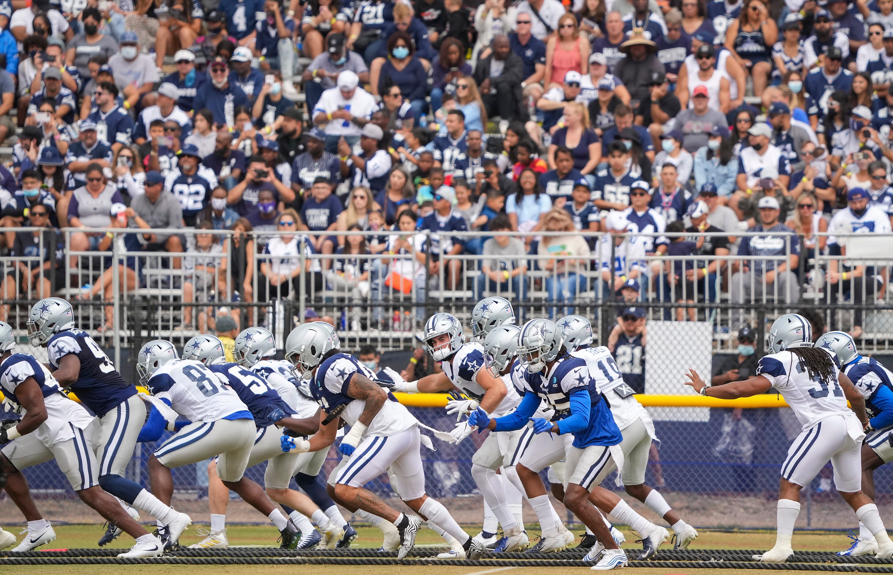 A full grandstand of fans watches as the Dallas Cowboys practice at training camp on...