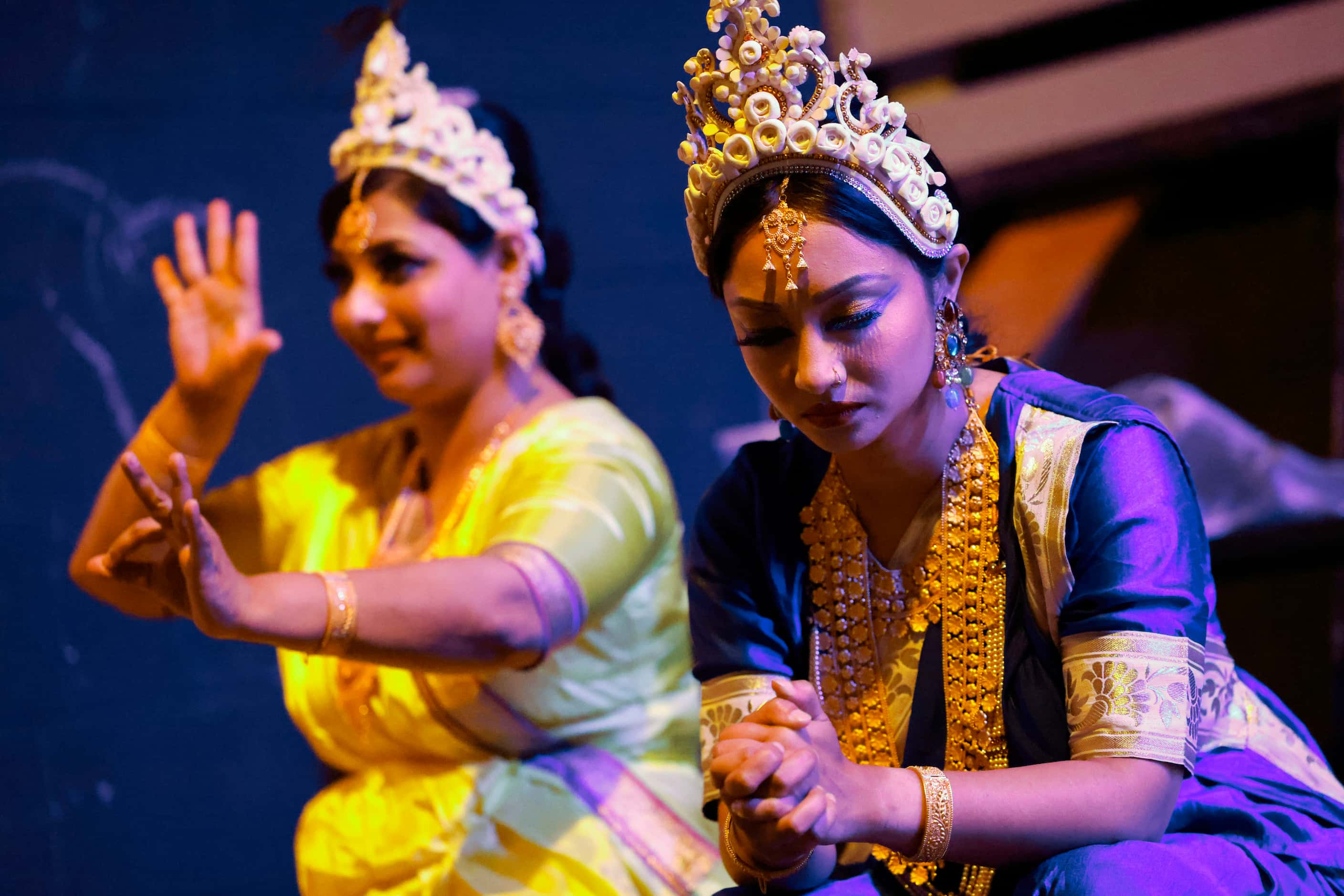 Cast members Nusrat Tinni (left) rehearses her dance steps as Arnila Nolok, meditates by the...