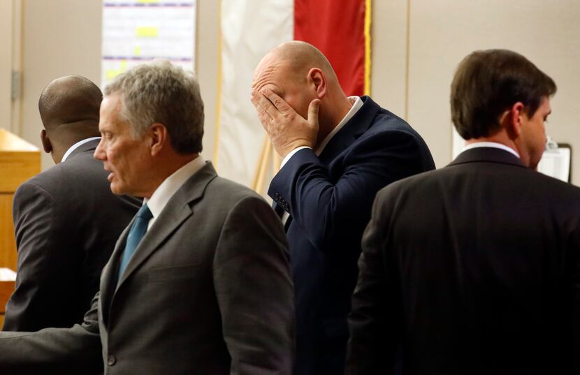 Former Dallas police officer Christopher Hess (middle) and his attorneys gathered at their...