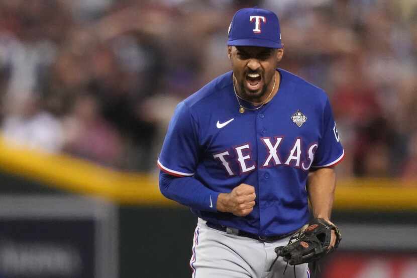 Texas Rangers second baseman Marcus Semien celebrates turning a double play, forcing out...