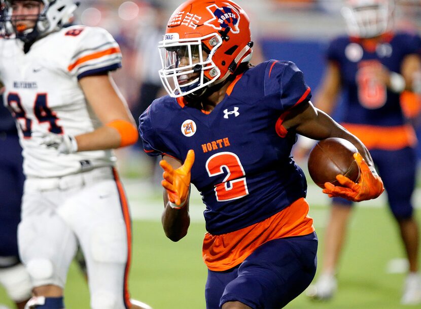 McKinney North High School wide receiver J.J. Henry (2) carries the ball during the first...