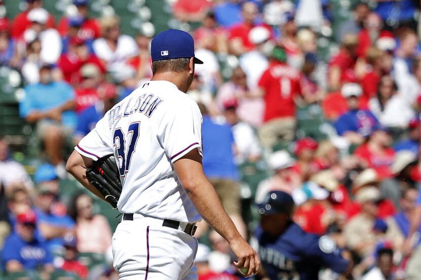 Texas Rangers relief pitcher Shawn Tolleson (37) watches Seattle Mariners' Robinson Cano...