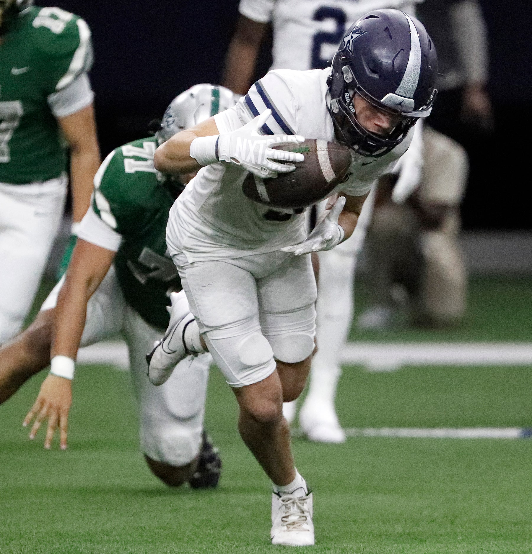 Lone Star High School wide receiver Marcus Vaughn (3) hangs on for a catch during the first...