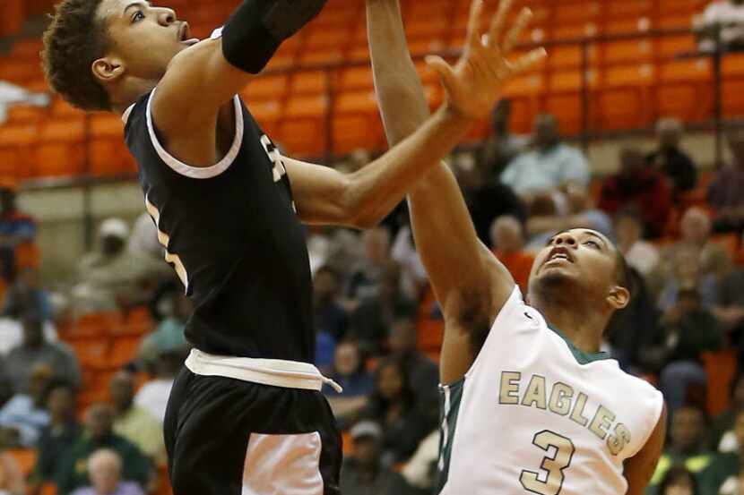 South Grand Prairie's Cameron Massey, left, goes up for a layup against DeSoto's Jordan...