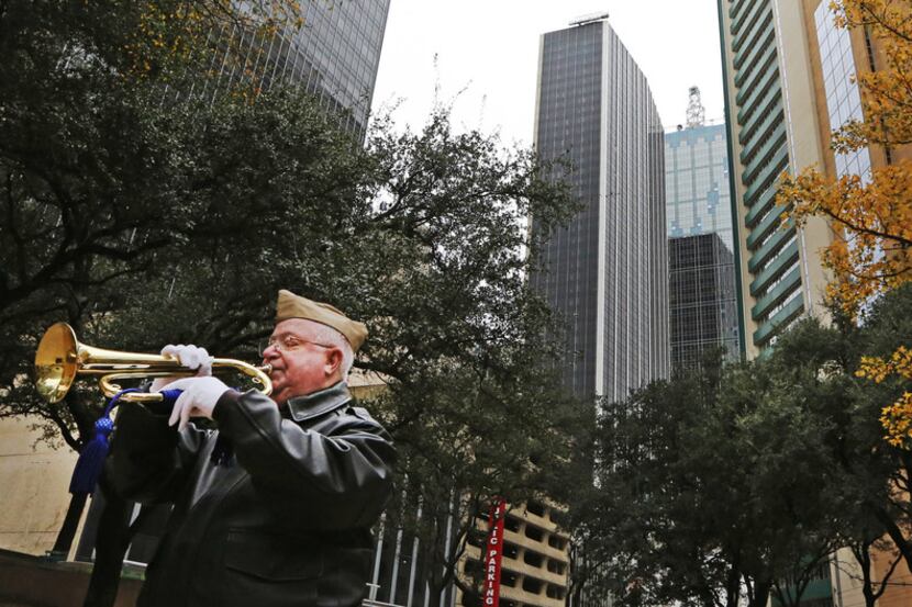 Bugler and Vietnam veteran Warren Hancock plays taps at the conclusion of a Pearl Harbor...