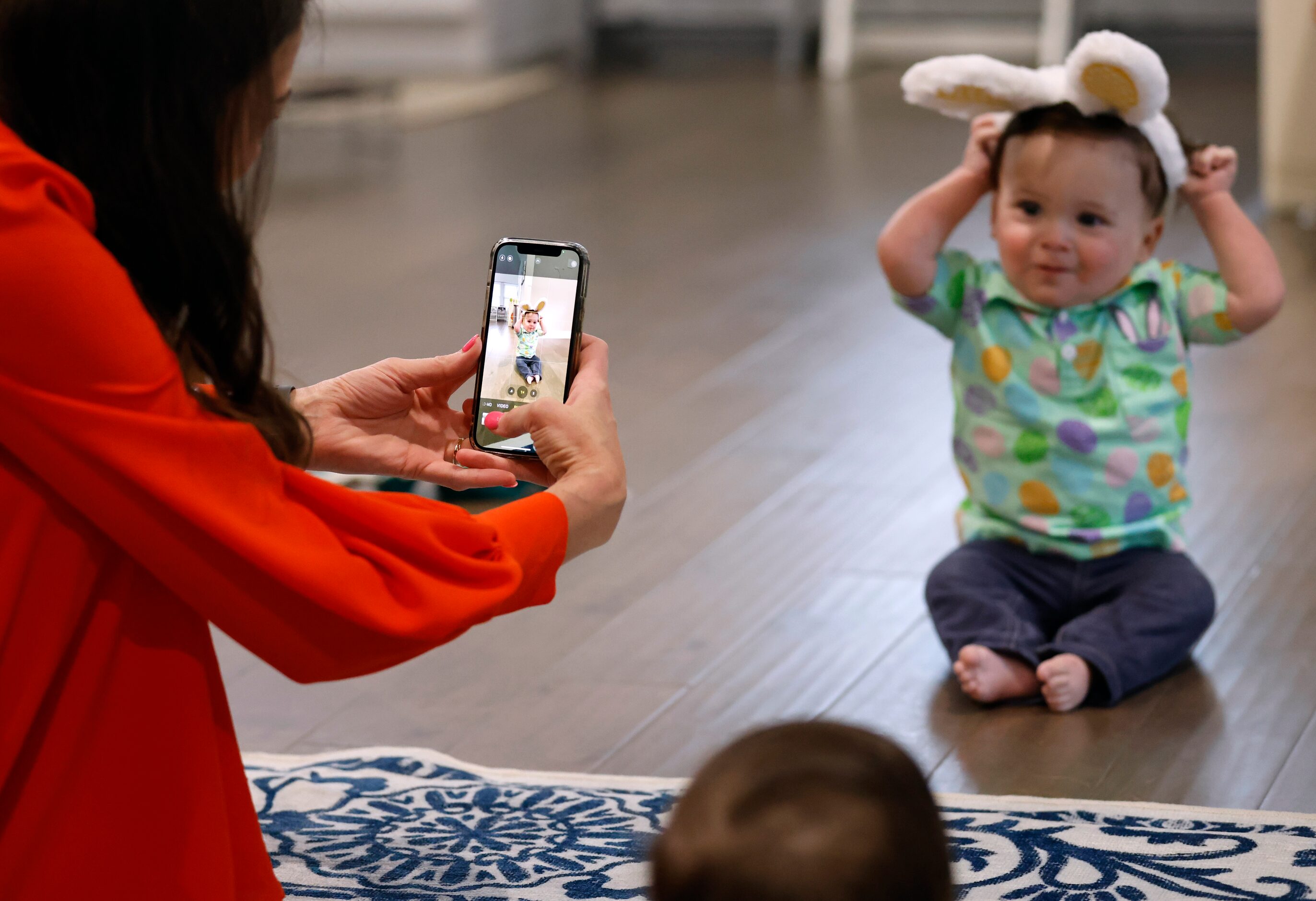 Jenny Marr takes a photo of Hudson Marr with bunny ears on after they went through items...