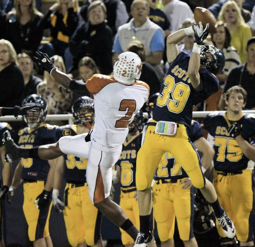 Highland Park High's Andrew Frost (39) grabs a long pass over West Mesquite High's Kameron...