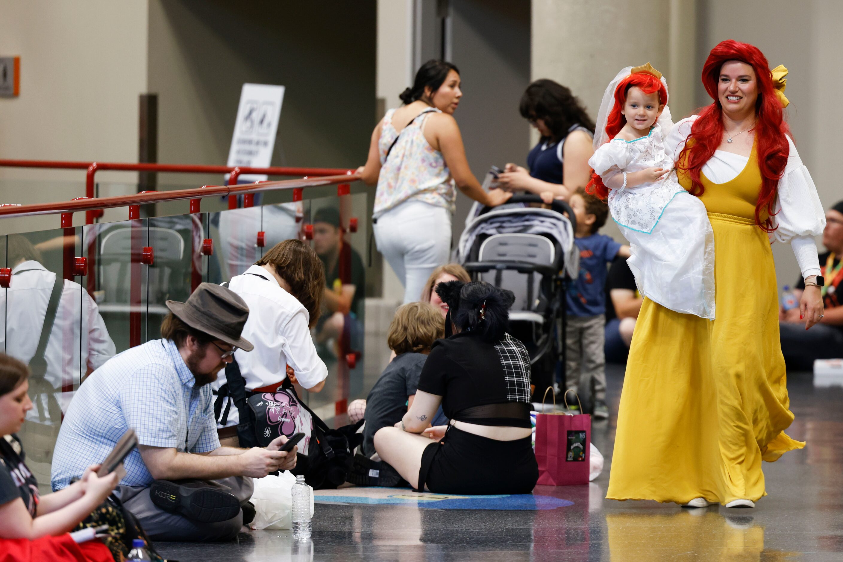 Amanda Blue and her daughter Aurora, 3, goes around Fan Expo Dallas on Friday, June 9, 2023,...