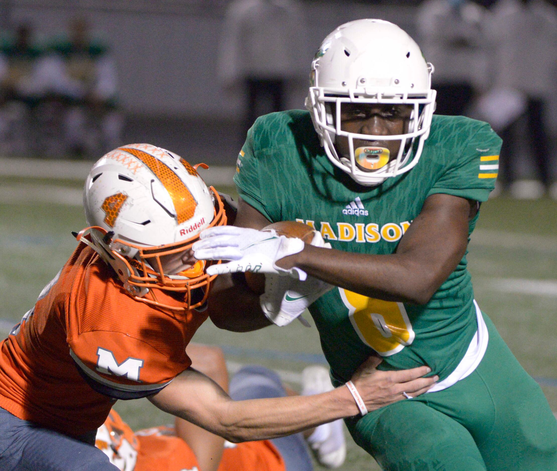 Madison’s Varrick Campbell (8) runs through a tackle attempt by Mineola’s Coy Anderson in...