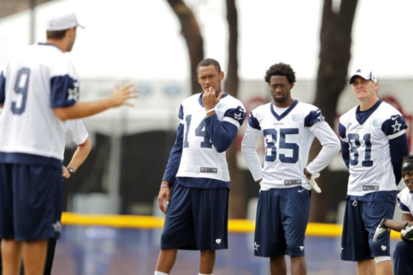 Dallas Cowboys wide receiver Eric Rogers (14), Jared Green (85), Danny Coale (81) listen as...